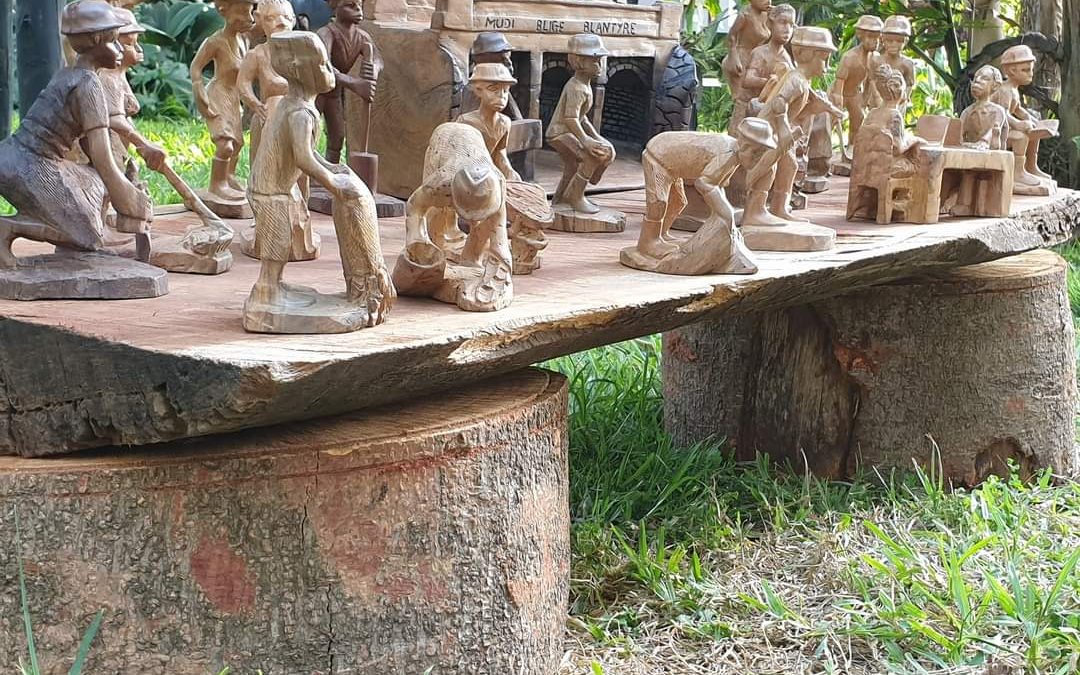 A collection of small wooden carvings, mostly of people